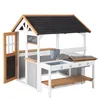 A wooden playhouse with a kitchen and picnic table. Anteprima dell’immagine prodotto