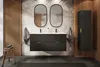 A modern bathroom vanity with two sinks, a large mirror, and a tall cabinet, decorated with palm leaf wallpaper. Anteprima dell’immagine prodotto