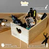 A wooden storage box filled with tools, placed on a cork-like surface. Produktbild-Vorschau