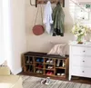 A hallway or entryway scene featuring a shoe cabinet with a bench, coats on a rack, and a dresser with flowers. Náhľad obrázku produktu