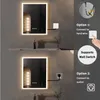 Two illuminated bathroom mirrors are shown, with options for connecting to hardwire or an outlet illustrated. Náhled obrázku produktu