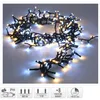 A string of microcluster Christmas lights with both warm white and white LEDs, coiled on a light gray surface. Produktbild-Vorschau