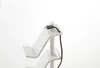 A close-up shot of a white controller stand with a USB cable plugged into the top. Produktbild-Vorschau