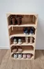A wooden crate shoe rack with shoes on each shelf. Produktbild-Vorschau
