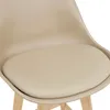A close-up view of the seat and part of the backrest of a beige bar stool, with wooden legs visible at the bottom. Náhľad obrázku produktu
