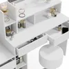 A white vanity table with drawers and shelves, filled with various cosmetic products and accessories, and a white stool. Voir les images du produit