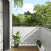 A balcony with a grey privacy screen, plants, and a view of trees. Náhled obrázku produktu