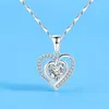 A silver heart-shaped pendant necklace with a clear gemstone in the center, set against a light blue background. Anteprima dell’immagine prodotto