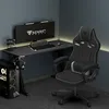 A gaming setup in a room with a desk, chair, computer, and monitor. Anteprima dell’immagine prodotto