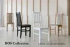 Four chairs are displayed in a room with a light-colored wooden wall and a light-colored floor. The chairs are of different colors and styles. Produktbild-Vorschau