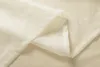A close-up of folded cream-colored sheer fabric with a hemmed edge. Produktbild-Vorschau