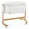 A white and wood baby bassinet on a white background. Produktbild-Vorschau