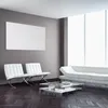 A modern living room with white furniture and a large window. Voir les images du produit
