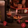A coffee machine is brewing espresso into a glass cup, with coffee capsules and a slice of cake on the side. Náhľad obrázku produktu