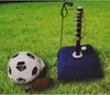 A soccer training set with a ball, pump, and rebounder is placed on a grassy lawn. Produktbild-Vorschau