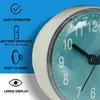 A close-up of a clock face with marketing text and icons on the left. Produktbild-Vorschau