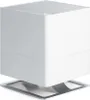 A white humidifier with a silver base is shown against a white background. Produktbild-Vorschau