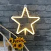 A star-shaped neon light is mounted on a brick wall above a bouquet of sunflowers on a staircase. Produktbild-Vorschau