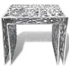 A silver aluminum side table with a geometric, cut-out design. Produktbild-Vorschau