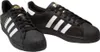 A pair of black Adidas Superstar sneakers with white stripes and gold accents. Voir les images du produit