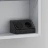 A black electrical outlet with two sockets is placed on a white shelf inside a cabinet. Produktbild-Vorschau