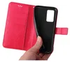 A hand is holding a red flip phone case open, revealing the black inner shell where a phone would be placed. Produktbild-Vorschau