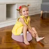 A young girl sits on a pink potty in a room with wooden floors. Náhľad obrázku produktu