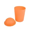An orange trash can with its lid next to it, isolated on a white background. Produktbild-Vorschau