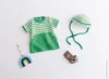 A flat lay of knitted baby clothes and accessories. Produktbild-Vorschau