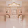 A clean, modern interior with pink and gold accents, featuring toffee machines and seating areas. Voir les images du produit