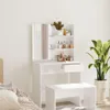 A white vanity table with a mirror and shelves filled with cosmetics, next to a potted plant. Náhled obrázku produktu