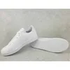 A pair of white Adidas sneakers with pink accents on a light gray textured background. Podgląd zdjęcia produktu