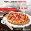 A pizza and pizza accessories on a stone. Produktbild-Vorschau