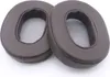Two brown ear pads for headphones are shown on a white background. Podgląd zdjęcia produktu