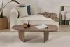 A living room scene with a couch, coffee table, and decor. Produktbild-Vorschau