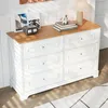 A white dresser with a wooden top is shown in a room with natural light. Anteprima dell’immagine prodotto