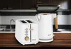 A white toaster and kettle set with wood accents are displayed on a wooden table in a kitchen setting. Voir les images du produit