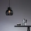 A black pendant light hangs above a shelf with two glasses of coffee and a moka pot. Produktbild-Vorschau