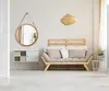A living room scene with a sofa, mirror, and cabinet. Produktbild-Vorschau