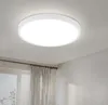 A white, circular LED ceiling light is mounted on a white ceiling. Produktbild-Vorschau