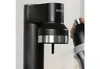 A close-up of a black Brita soda maker with a hand holding a bottle to insert it. Produktbild-Vorschau