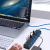 A laptop, keyboard, and USB hub are set up on a desk, with a hand reaching towards the keyboard. Produktbild-Vorschau