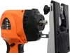A close-up view of the front of an orange and black rotary tool with a silver attachment. Náhľad obrázku produktu