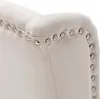 A close-up view of the studded trim of a beige upholstered chair. Anteprima dell’immagine prodotto