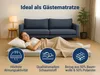 A woman is sleeping on a foldable mattress in front of a sofa, with marketing icons and text displayed. Produktbild-Vorschau