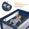 A baby sleeping in a travel crib with a patterned mattress. Anteprima dell’immagine prodotto