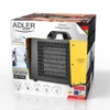 The image shows the packaging of an Adler AD 7740 ceramic fan heater. The packaging is colorful and features images of the product, along with text describing its features and brand. Náhled obrázku produktu