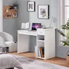 A white desk with a laptop, lamp, and books in a room with a white chair and a bed. Produktbild-Vorschau