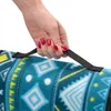 A hand holding a handle of a rolled-up blanket. Náhled obrázku produktu