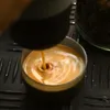 Espresso being poured into a cup from a coffee machine. Produktbild-Vorschau